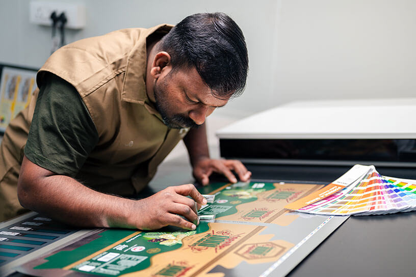 A person is machining the color for box packaging printing